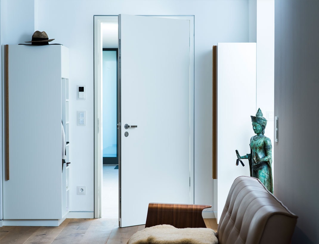 Modern white flush exterior door in contemporary home