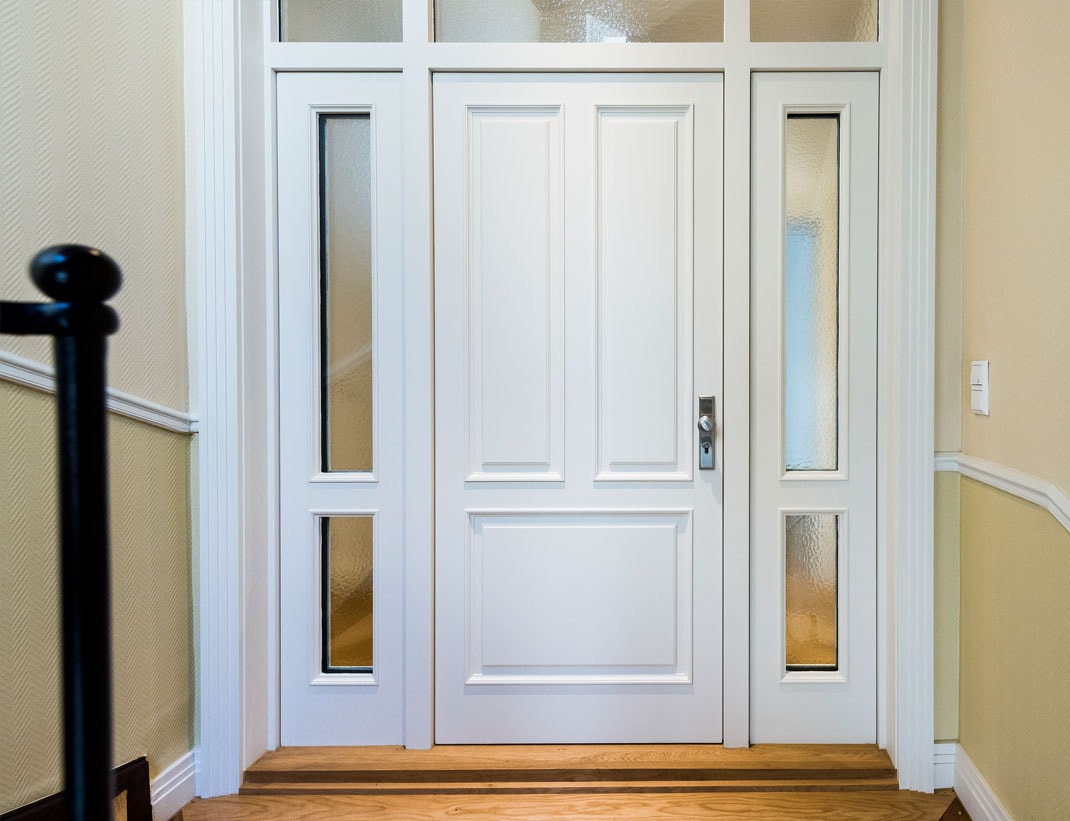White panel exterior door with glass sidelights and transom