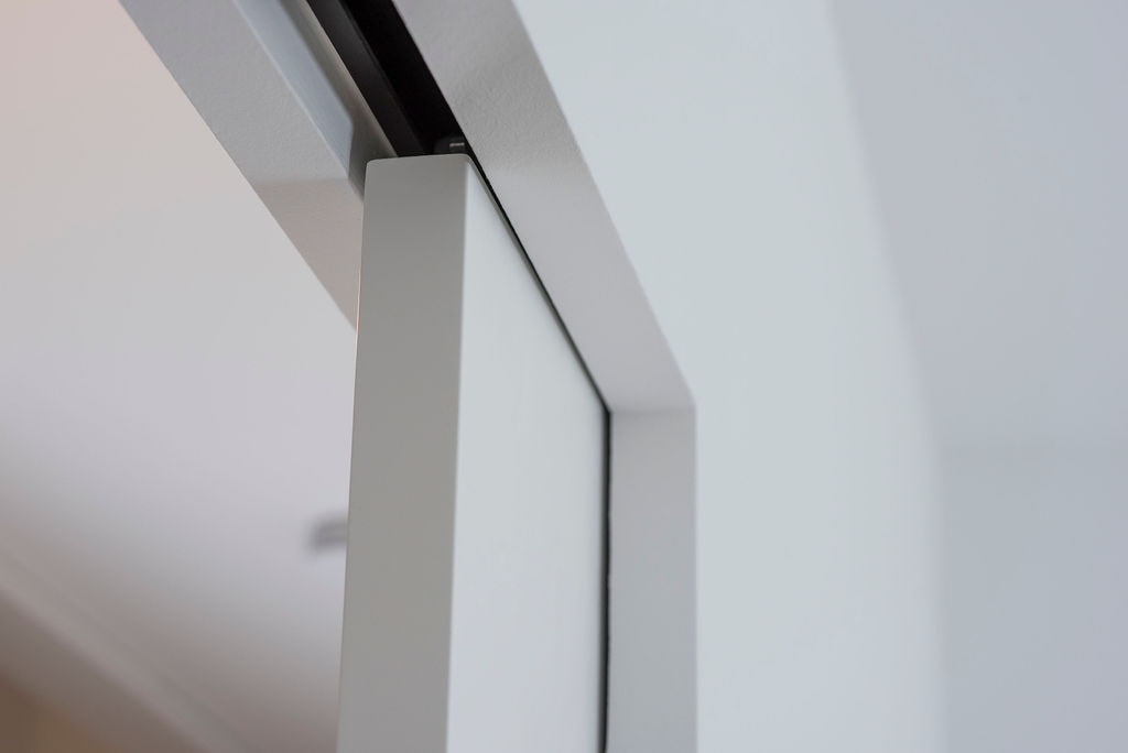 Premium pocket door with soft-stop mechanism